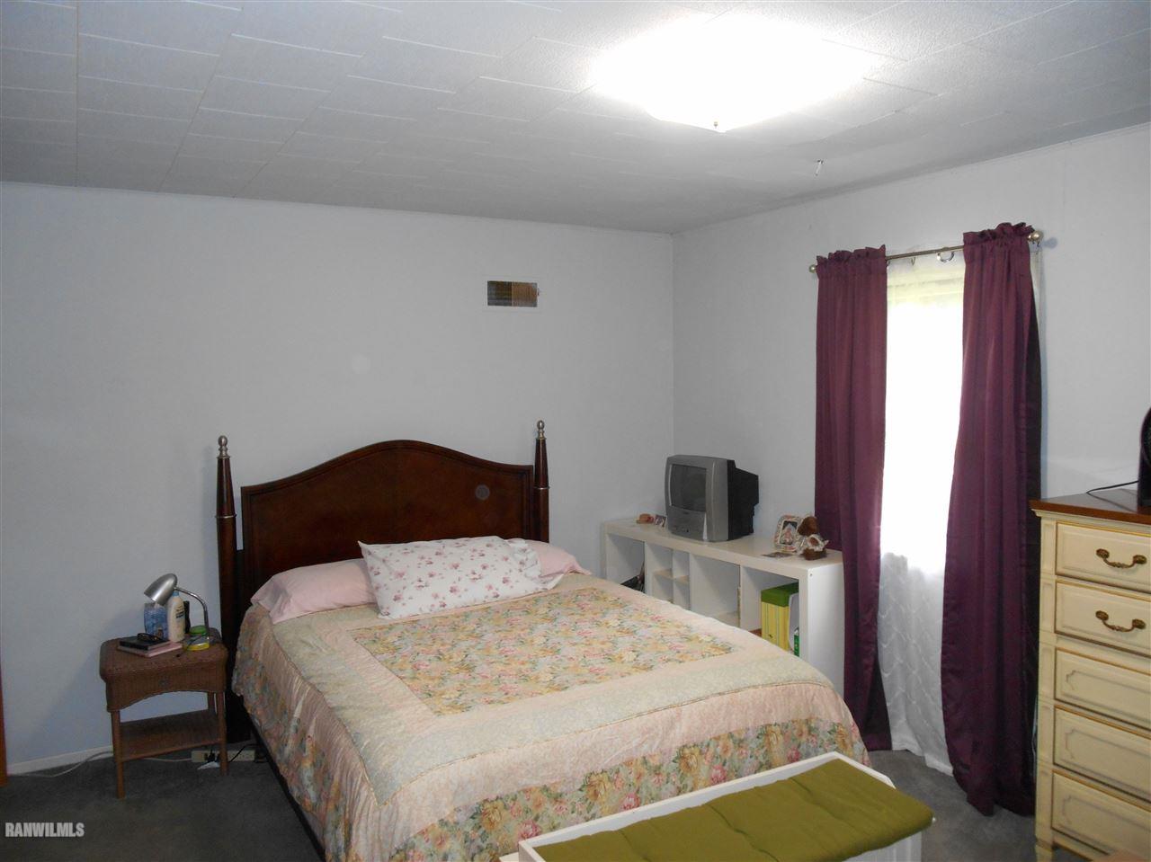 2321 Lancaster Heights Road Freeport, IL 61032 - Photo 7 of 17 a bedroom with a bed and a flat tv screen on dresser
