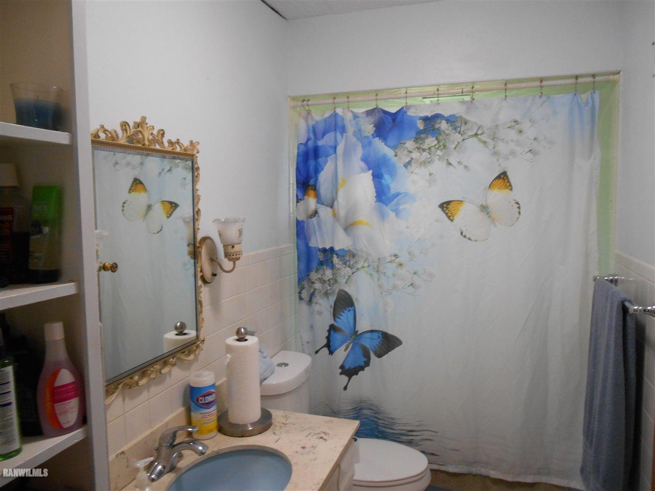2321 Lancaster Heights Road Freeport, IL 61032 - Photo 8 of 17 a bathroom with a toilet and a shower curtain