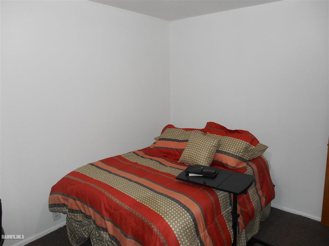 2321 Lancaster Heights Road Freeport, IL 61032 - Photo 10 of 17 a bedroom with a bed and a lamp