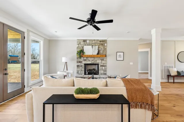 a dining room with furniture potted plants and wooden floor