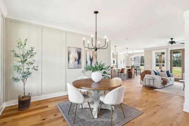 a kitchen with stainless steel appliances granite countertop a stove a sink a refrigerator and a wooden cabinets