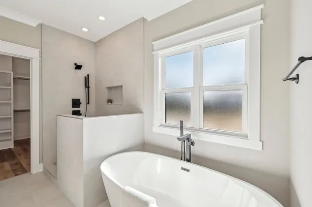 a view of a livingroom with a ceiling fan and window