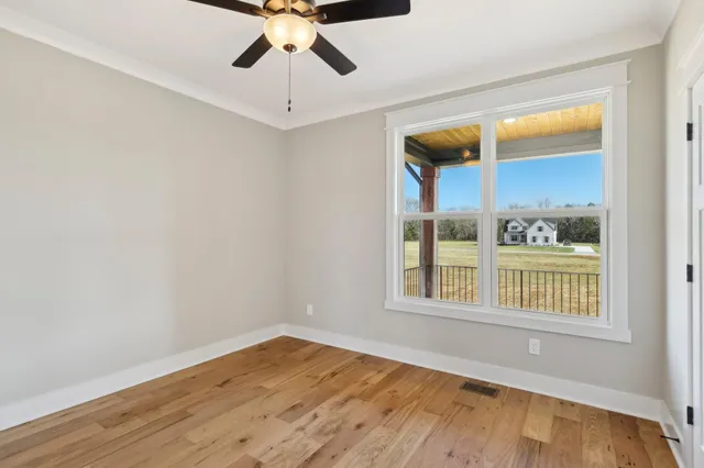 a white toilet sitting in a bathroom next to a window