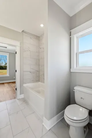 a view of a livingroom with a ceiling fan and window