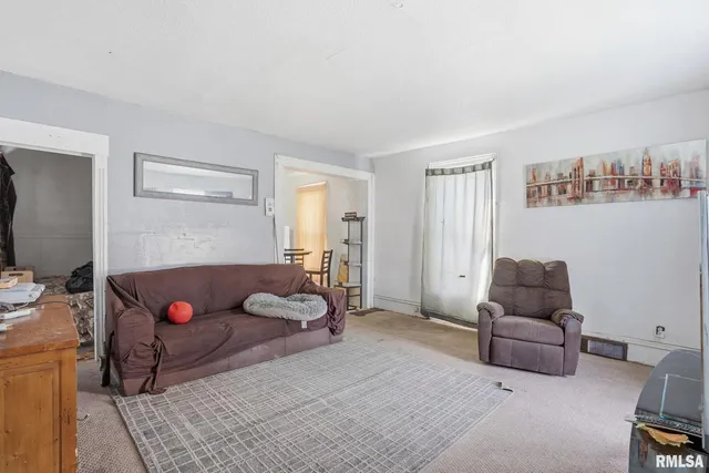 a living room with furniture chess board and a couch