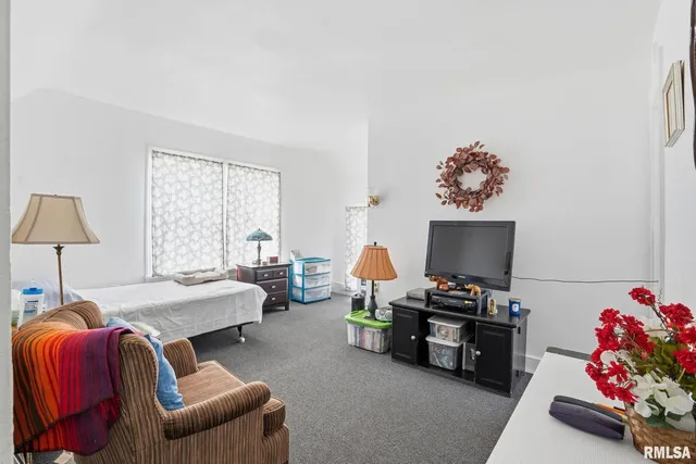 a bedroom with furniture and a window