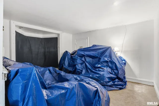a bed sitting in a bedroom next to a cabinet