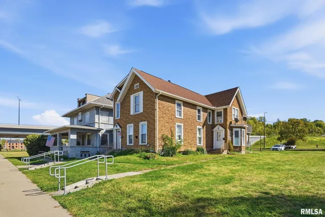 a front view of a house with a yard table and chairs