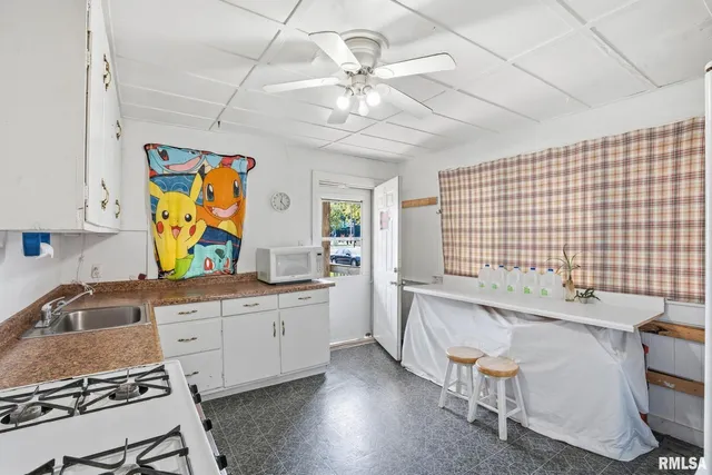 a kitchen with a sink cabinets and window