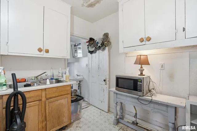 a kitchen with stainless steel appliances white cabinets and a sink