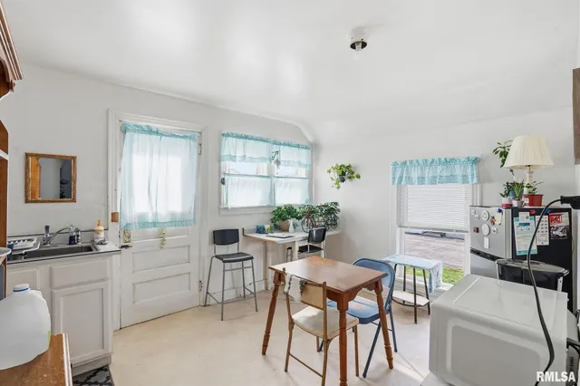 a view of a dining room with furniture and window
