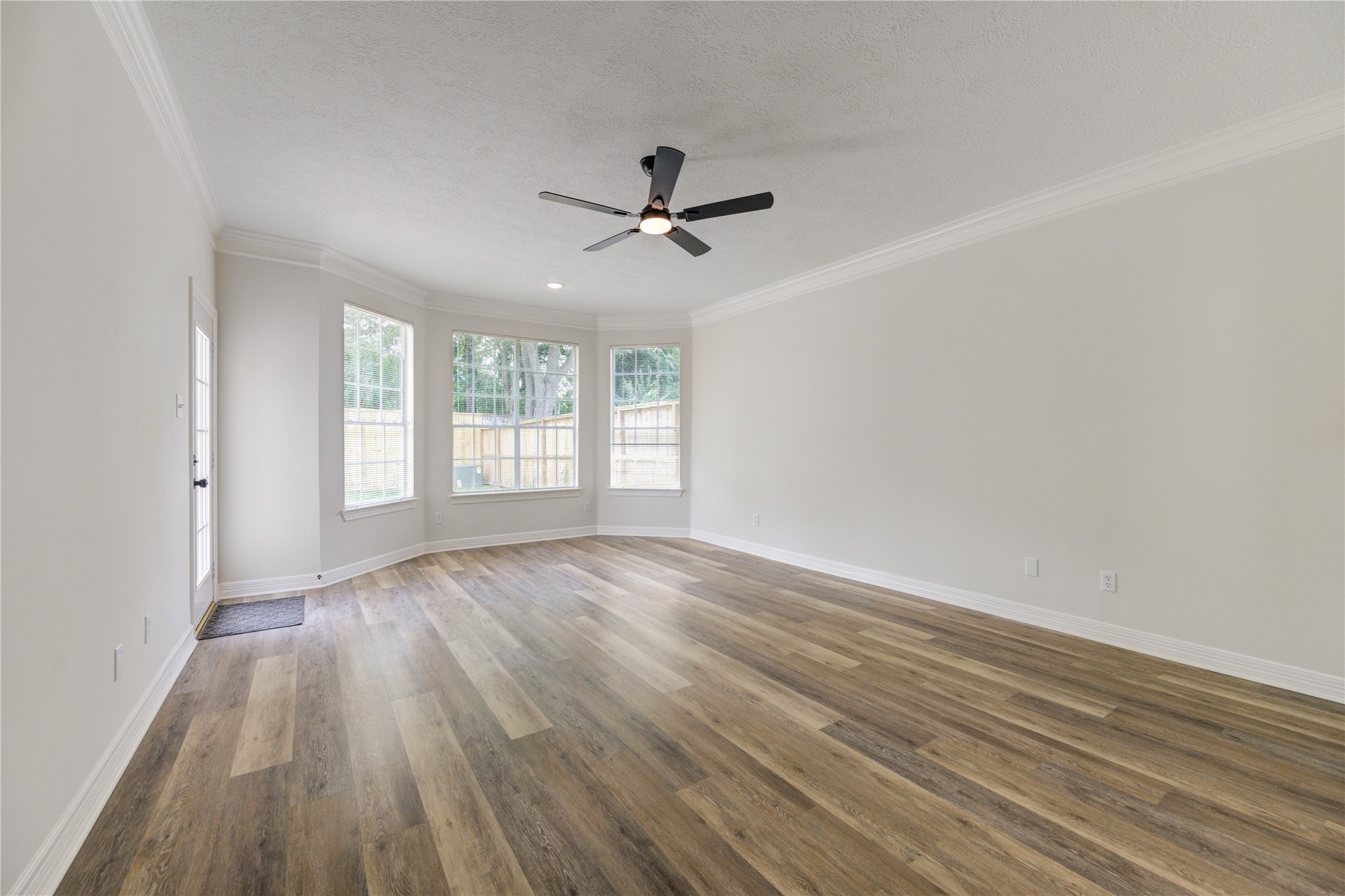 17318 Bonnard Circle Spring, TX 77379 - Photo 24 of 45 The large primary bedroom is downstairs and has bay-style windows, high ceilings with crown molding, a new remote-controlled ceiling fan, new paint and beautiful new floors. There is also a private exterior door leading out to the beautiful flagstone covered back patio.