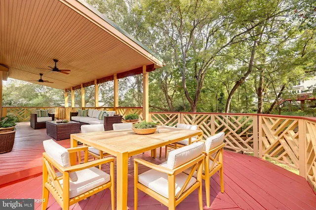 a kitchen with stainless steel appliances granite countertop a stove top oven a sink dishwasher a dining table and chairs with wooden floor