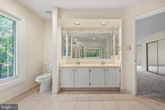a bedroom with a bed and a potted plant