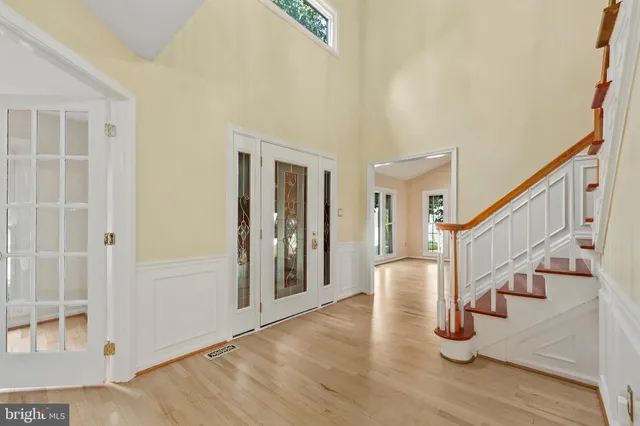 a view of entryway with wooden floor and stairs