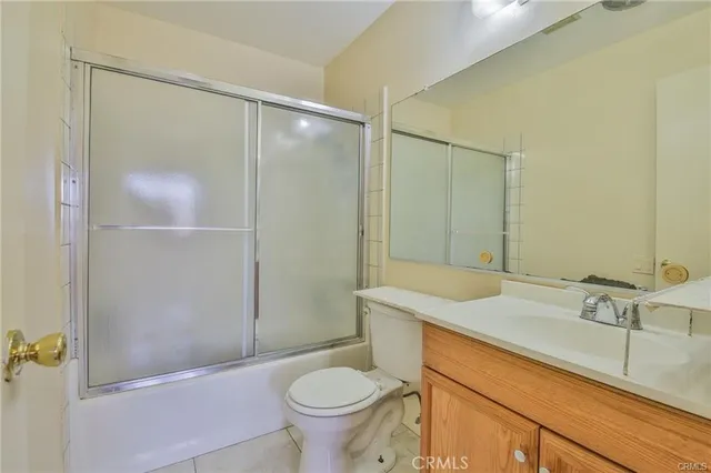 an empty room with wooden floor and closet