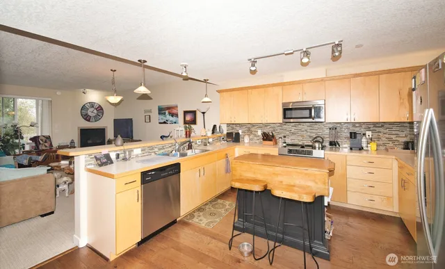 a room with furniture a sink and a large mirror