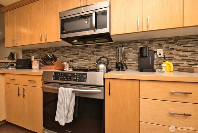 a living room with fireplace furniture and a window