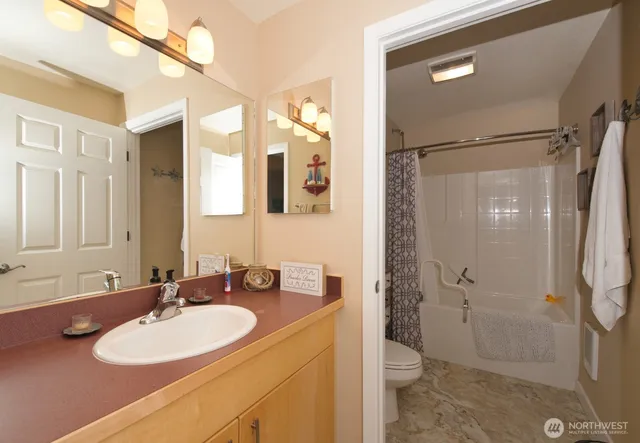 a white toilet sitting next to a bath tub