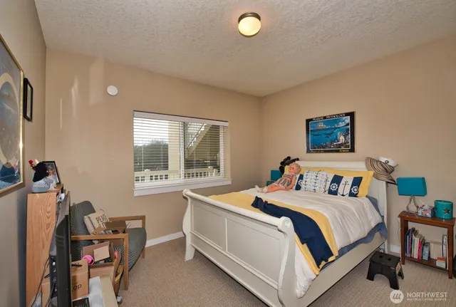 a bedroom with bed and a window