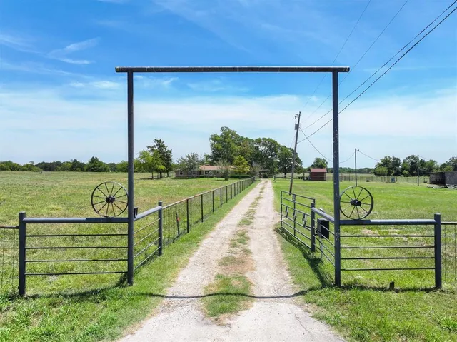 a view of a park with a floor to ceiling window and a lake view