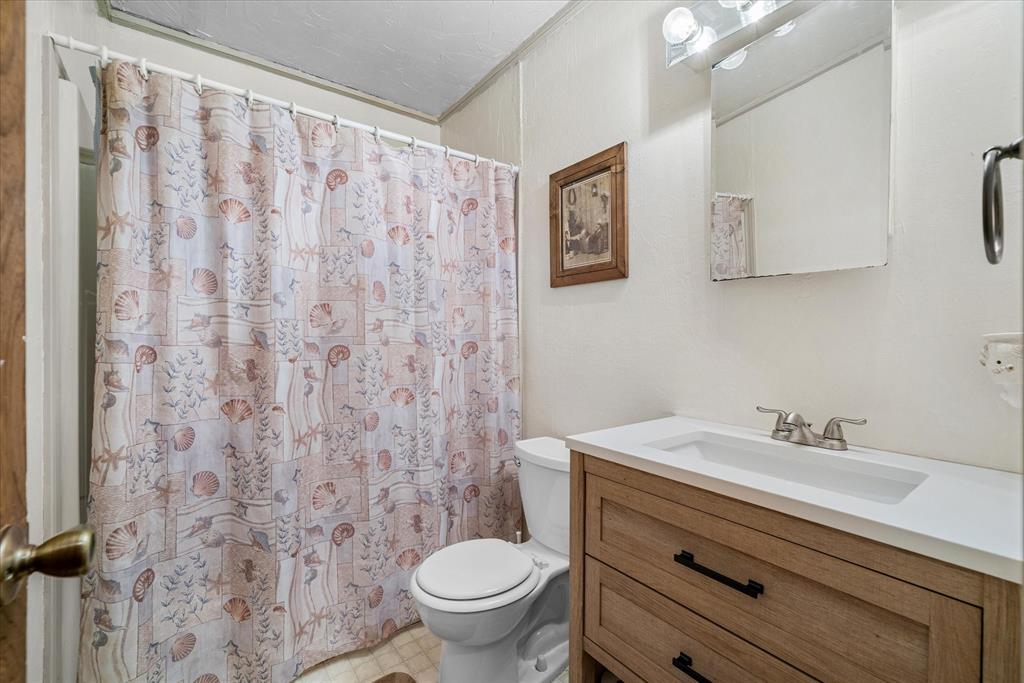 15374 Fm 2728 Terrell, TX 75161 - Photo 23 of 39 a bathroom with a sink a toilet and a mirror