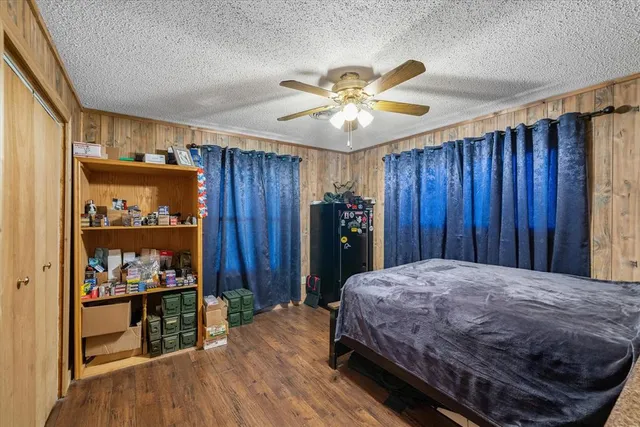 a bedroom with a bed and a bookshelf