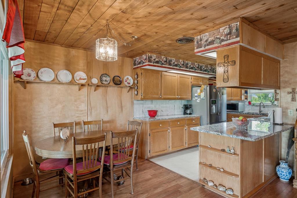 15374 Fm 2728 Terrell, TX 75161 - Photo 29 of 39 a dining room with furniture and a chandelier
