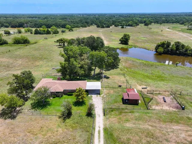 an aerial view of a house with outdoor space and lake view