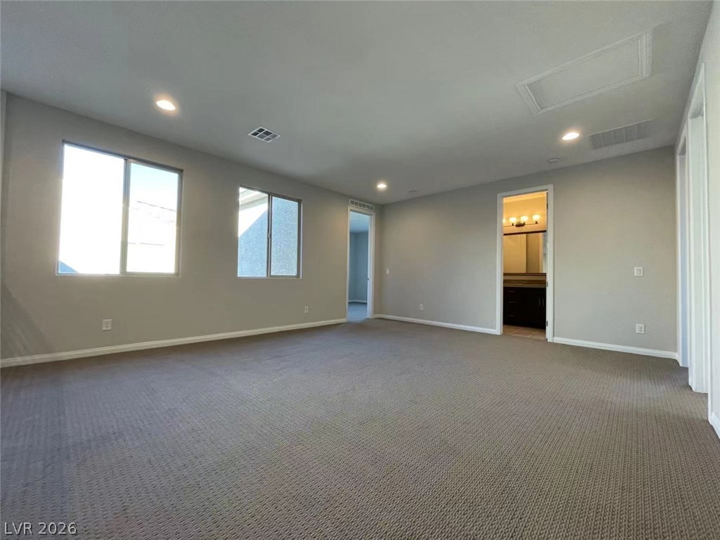 11 Rancho Maria Street Las Vegas, NV 89148 - Photo 12 of 27 Generous natural light fills this open room featuring plush carpeting and modern recessed lighting.