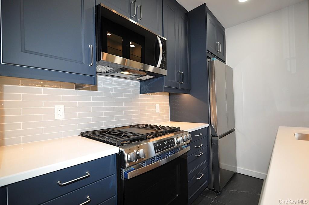 196 Garth Road, Unit 1G Scarsdale, NY 10583 - Photo 14 of 35 a stove top oven sitting inside of a kitchen