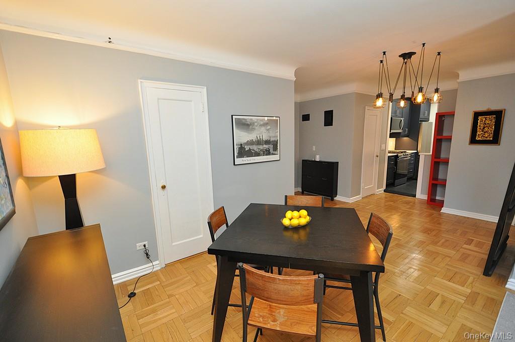 196 Garth Road, Unit 1G Scarsdale, NY 10583 - Photo 19 of 35 a view of a dining room with a table and chairs