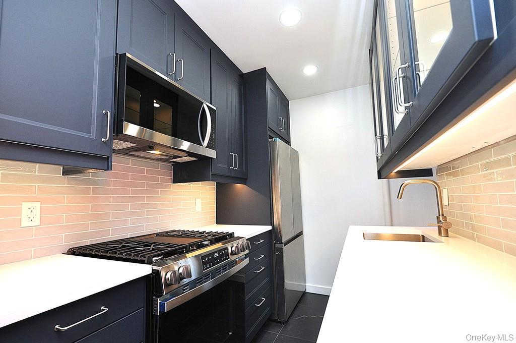 196 Garth Road, Unit 1G Scarsdale, NY 10583 - Photo 2 of 35 a stove top oven sitting inside of a kitchen