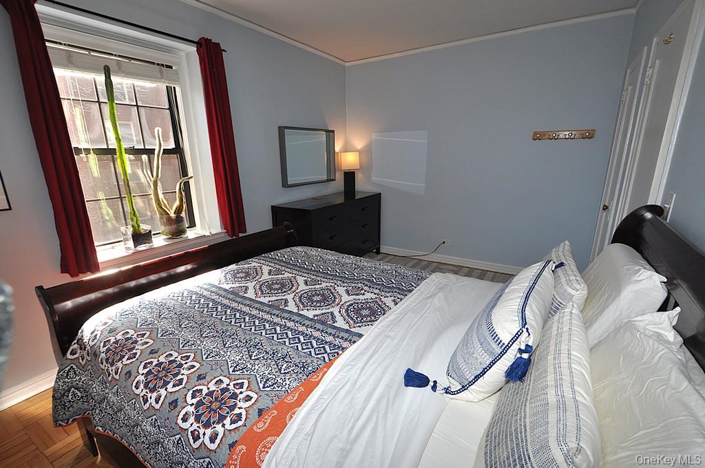 196 Garth Road, Unit 1G Scarsdale, NY 10583 - Photo 22 of 35 a bedroom with a bed and a window
