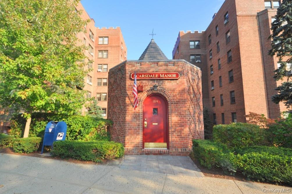 196 Garth Road, Unit 1G Scarsdale, NY 10583 - Photo 24 of 35 a front view of a multi story residential apartment building with yard