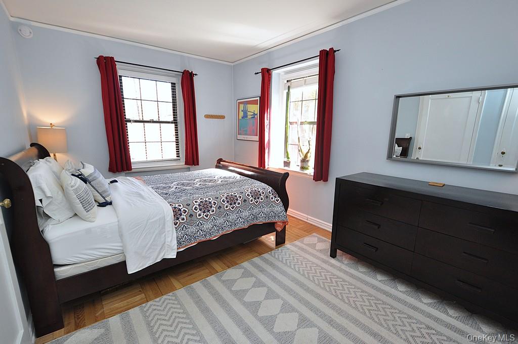 196 Garth Road, Unit 1G Scarsdale, NY 10583 - Photo 3 of 35 a bedroom with a bed wooden floor and window
