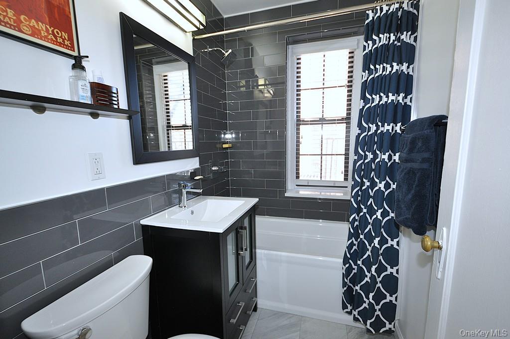 196 Garth Road, Unit 1G Scarsdale, NY 10583 - Photo 4 of 35 a bathroom with a sink a toilet and shower