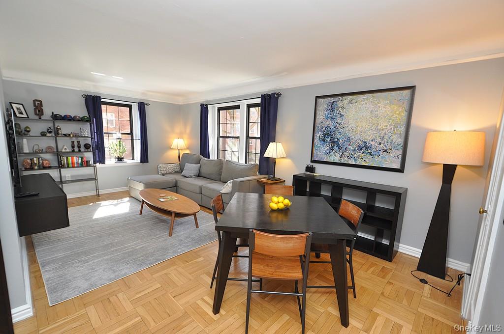 196 Garth Road, Unit 1G Scarsdale, NY 10583 - Photo 7 of 35 a living room with furniture and a flat screen tv