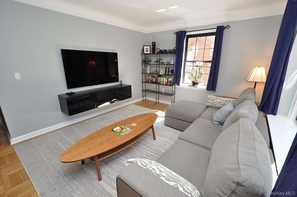 196 Garth Road, Unit 1G Scarsdale, NY 10583 - Photo 8 of 35 a living room with furniture and a flat screen tv
