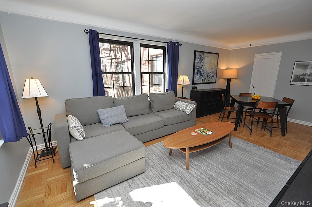 196 Garth Road, Unit 1G Scarsdale, NY 10583 - Photo 9 of 35 a living room with furniture and wooden floor