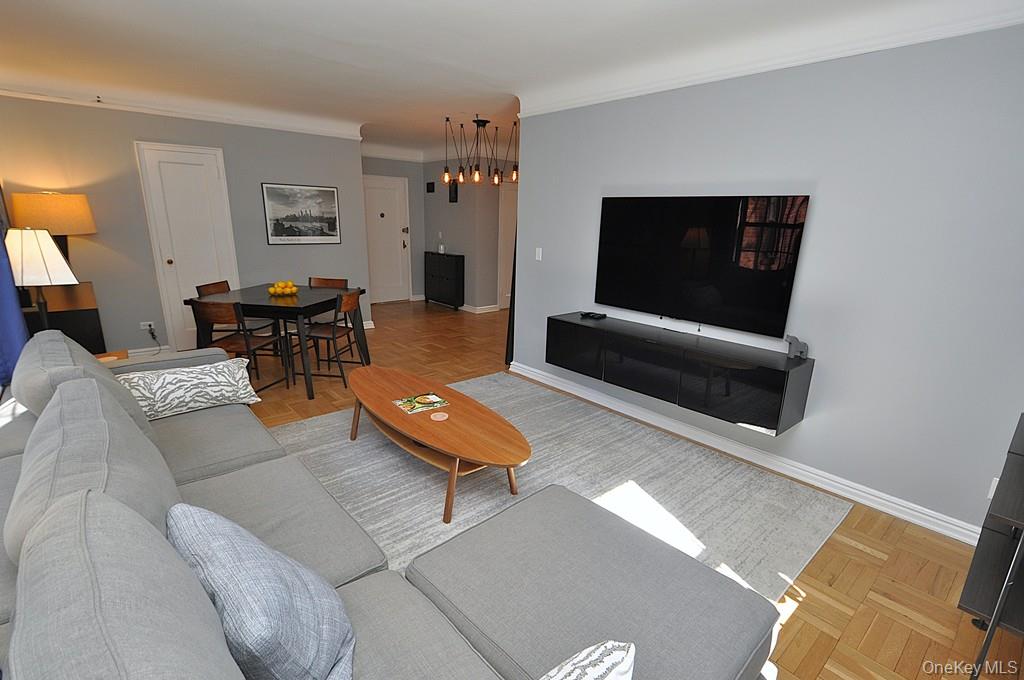196 Garth Road, Unit 1G Scarsdale, NY 10583 - Photo 10 of 35 a living room with furniture and a flat screen tv