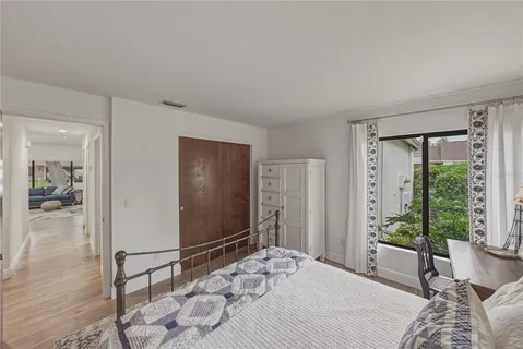 a bedroom with a bed and a lamp