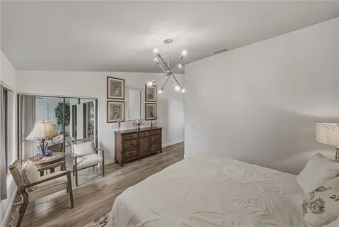 a dining room with furniture wooden floor and a potted plant