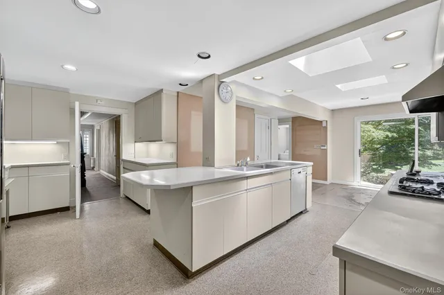 a kitchen with a sink stove and microwave