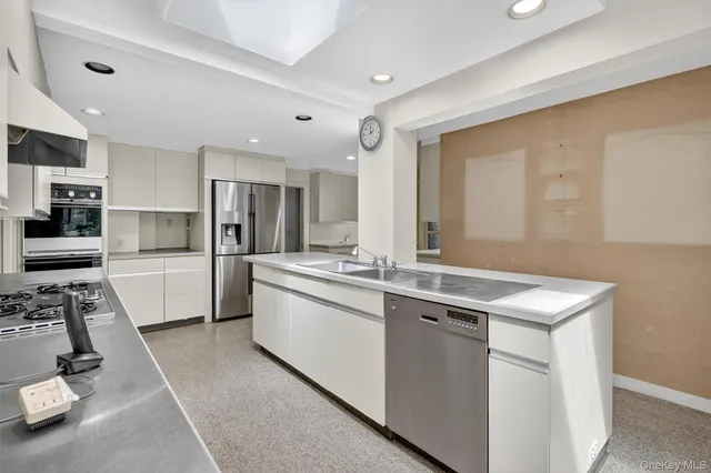 an empty room with windows and fireplace