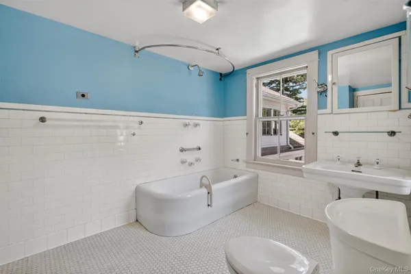 a bathroom with a toilet sink and shower