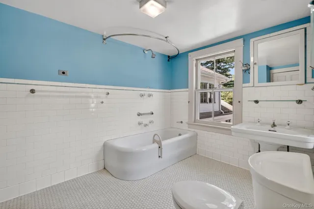 a bathroom with a toilet sink and shower