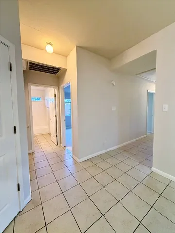 a view of a livingroom with an empty space and a window