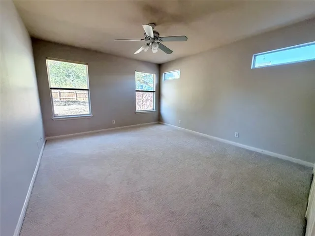 an empty room with windows and sink