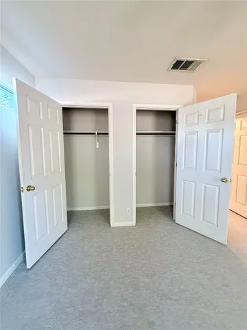 an empty room with closet area